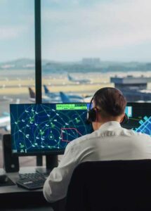 Air traffic navigator looking as screen tracking numerous airplanes